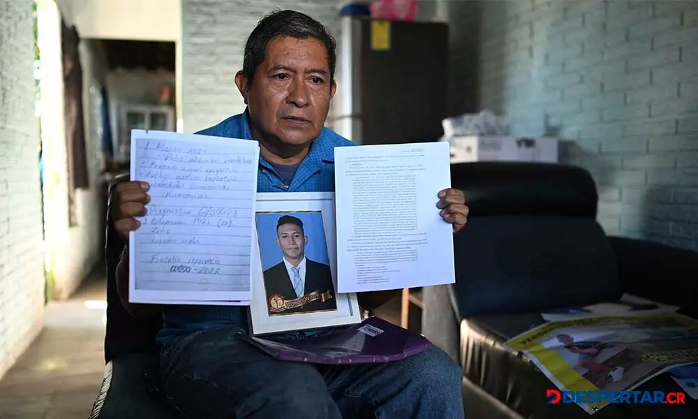 Reynaldo Santos muestra documentos y una foto de su hijo, Jonathan Santos, que fue arrestado desde 2022. Foto: Stringer / AFP.