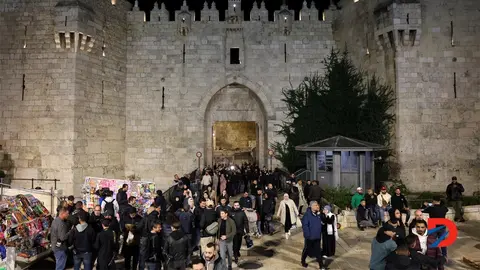 Palestinos caminan por la Puerta de Damasco, despu&eacute;s de atender una tarde de oraci&oacute;n, en el inicio del mes del Ramad&aacute;n. Foto: Ahmad Gharabli / AFP.