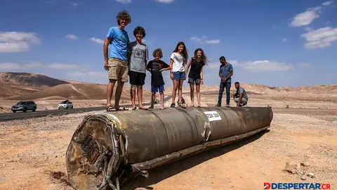 Algunas personas observan los restos de un misil iran&iacute;, en el desierto de Neguev, cerca de la ciudad de Arad. Foto: Menahem Kahana / AFP.